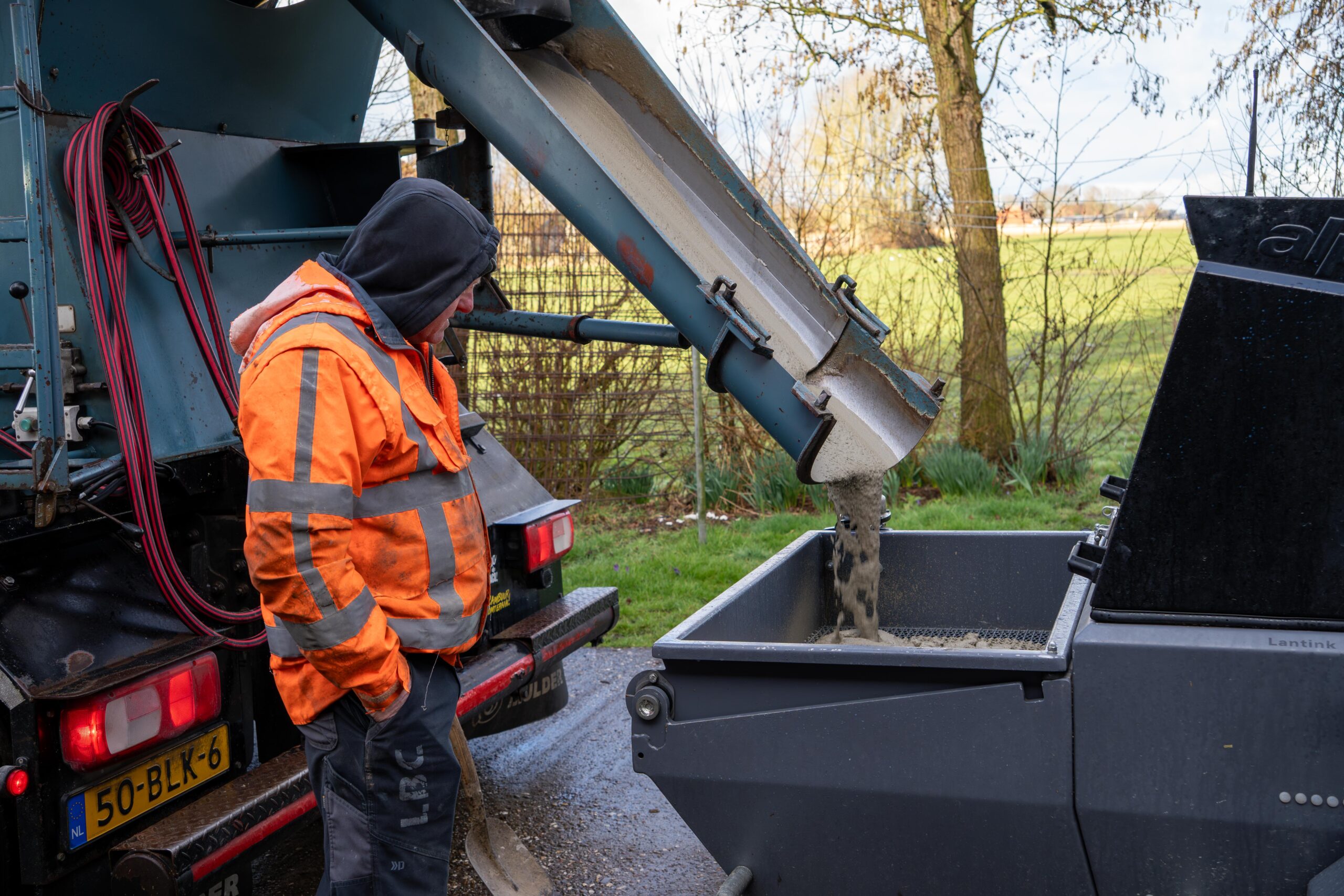 Een man laadt een vrachtwagen met beton-thermo floor friesland (Oudega)